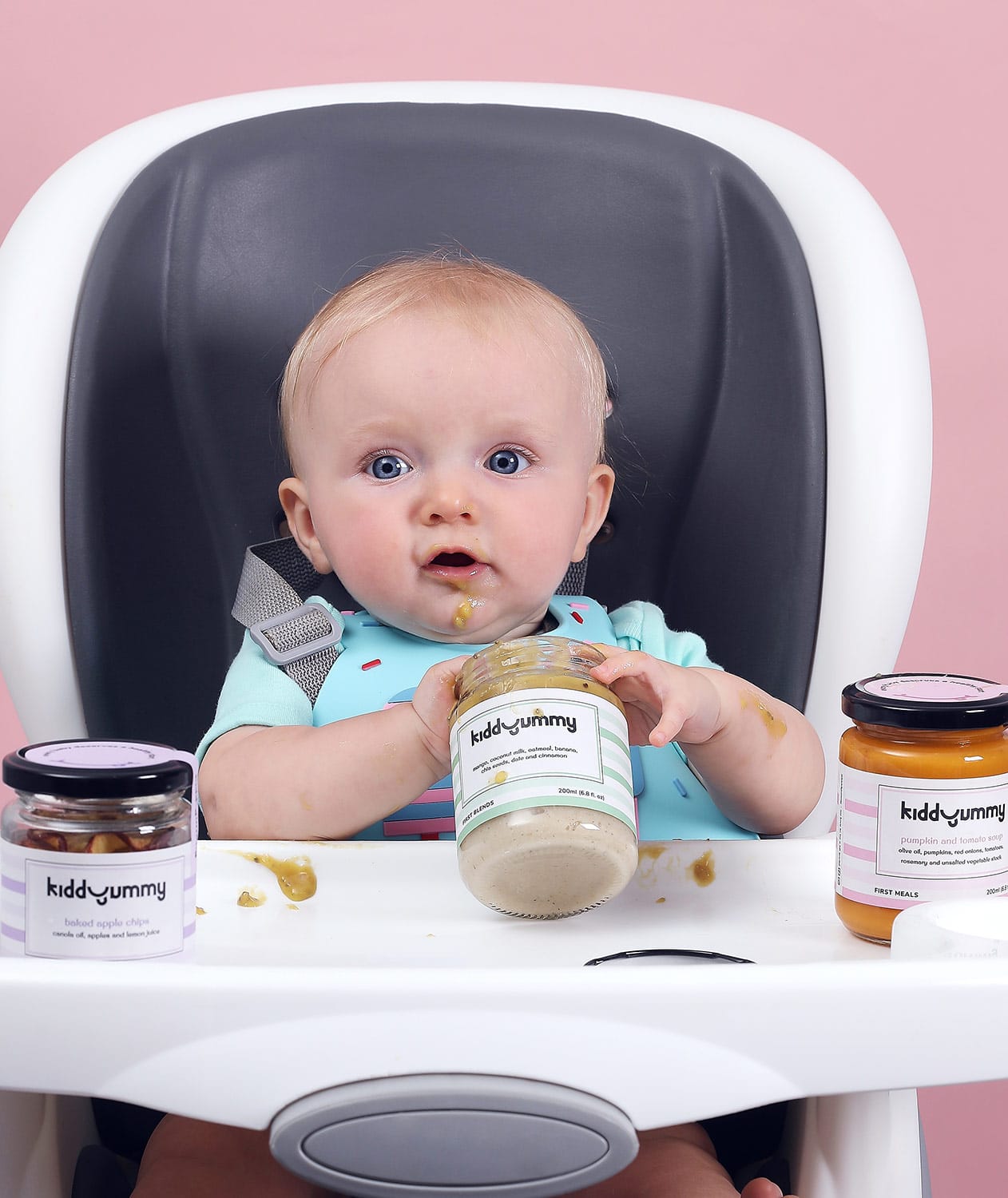 Western baby boy sitting on chair having Kiddyummy meal