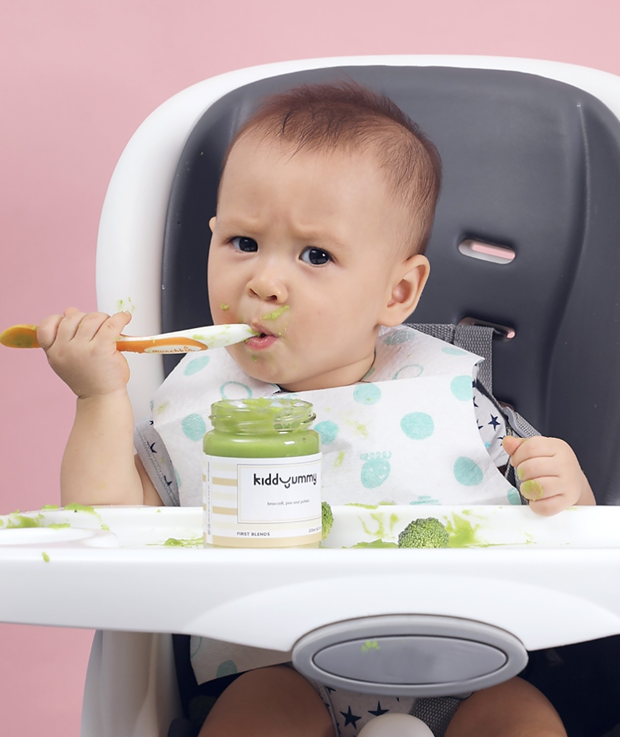 Asian baby boy sitting on chair having Kiddyummy meal