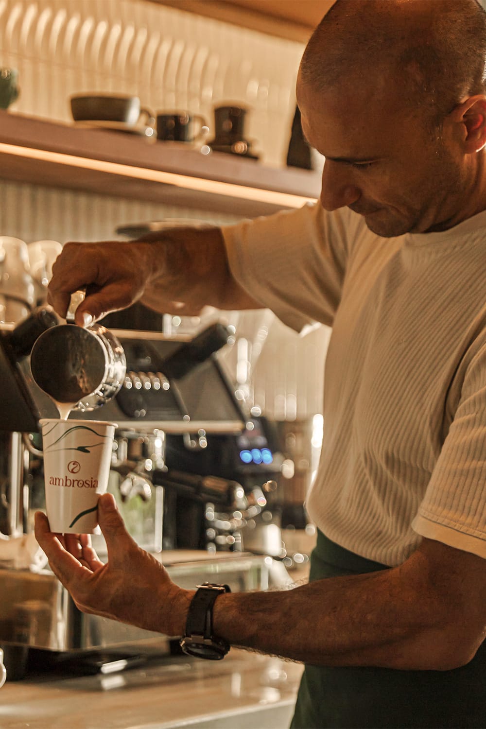 Ambrosia Barista Making A Latte