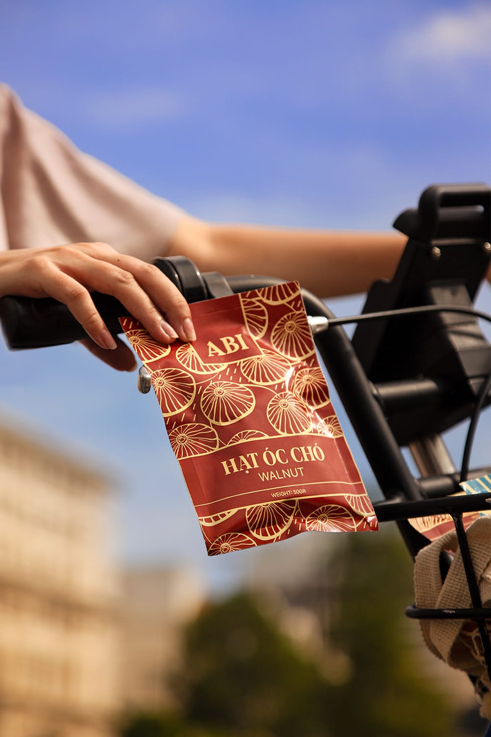 hand holding a pack of Abi walnut on bicycle