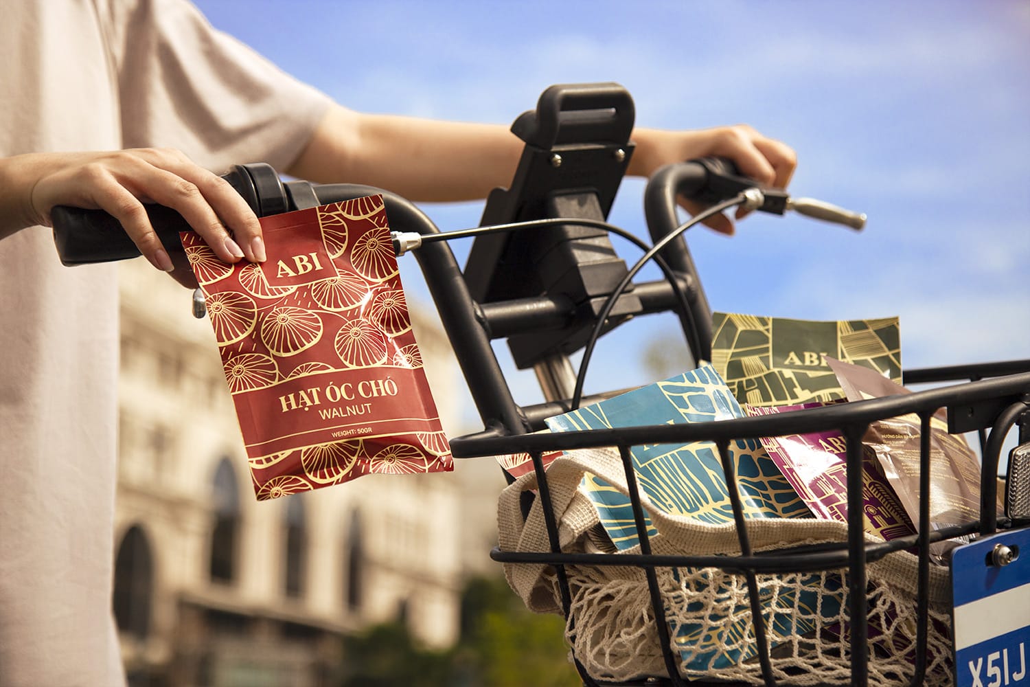 holding a pack of abi with full bicycle basket of abi