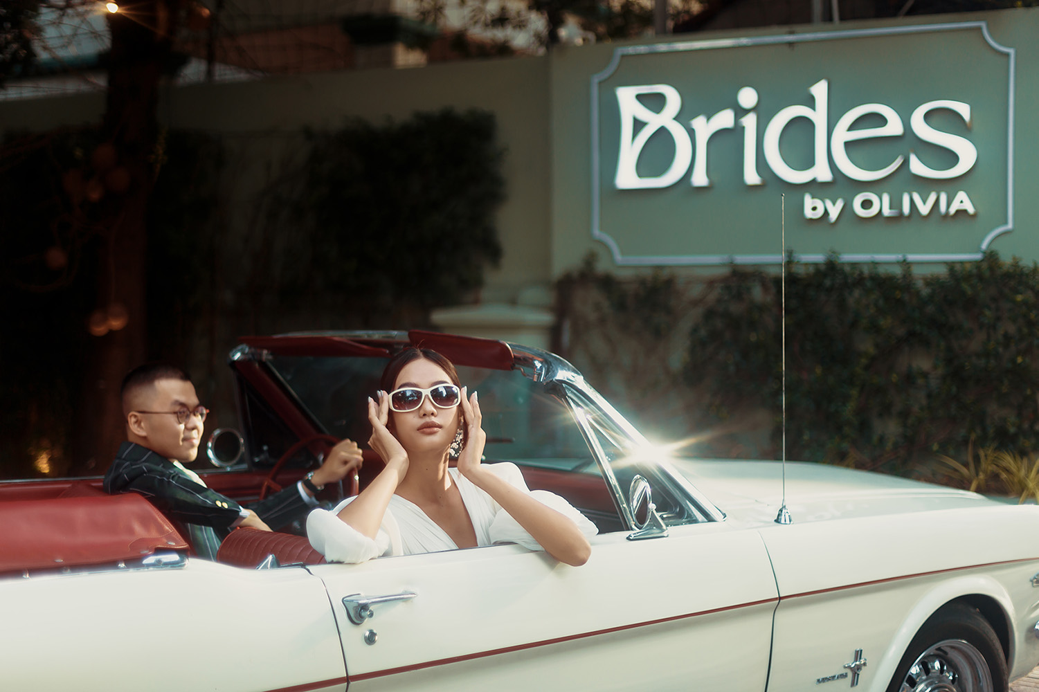 bride and groom shooting on a car