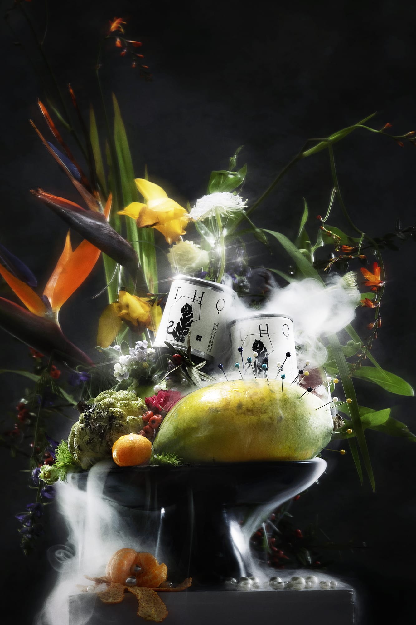 conceptual photoshoot of candle with fruits and flowers