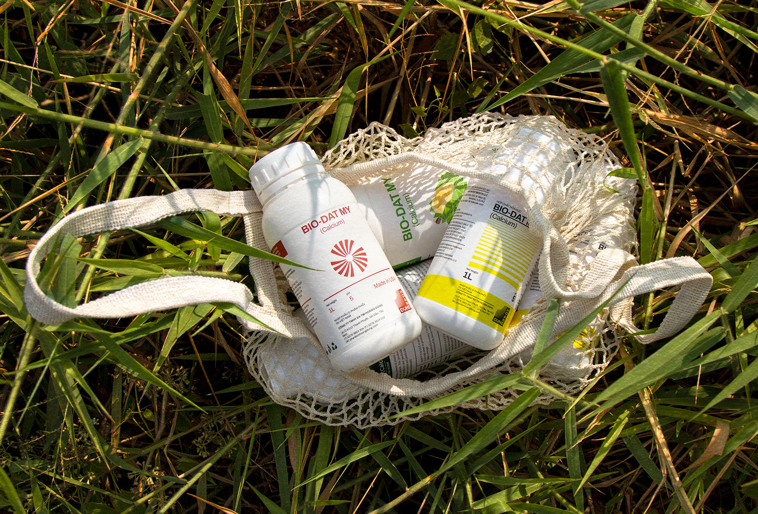 a bag of Hoang Dung bottles laying on grass
