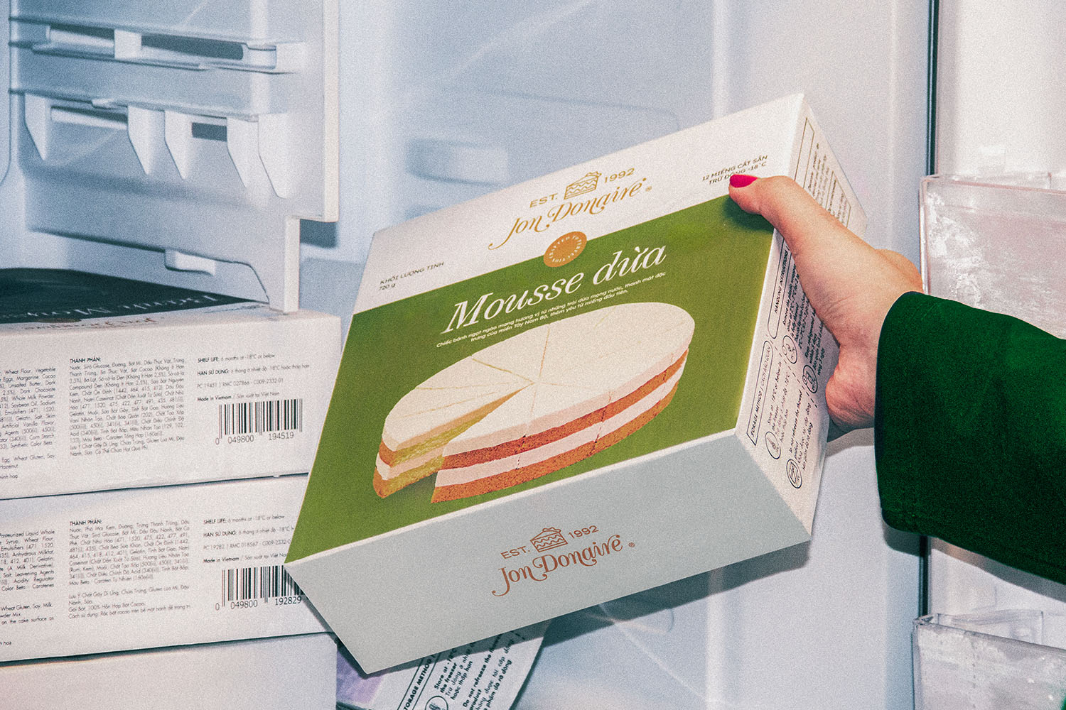 women hands taking Jon Donaire frozen cakes by Rich Products out of a fridge