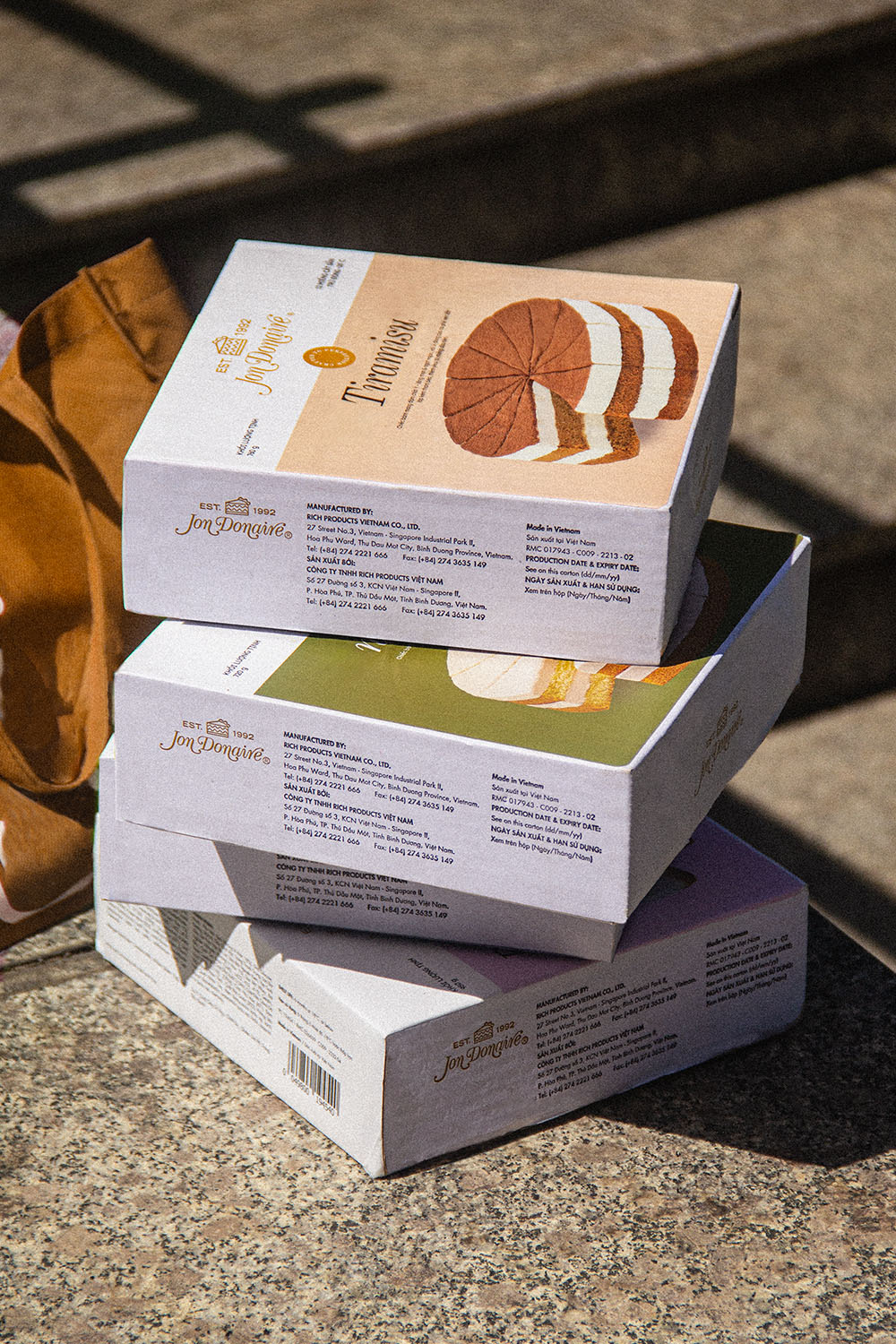 box packaging stacked on the ground Jon Donaire frozen cakes by Rich Products outdoor